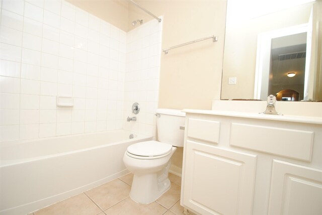 full bathroom featuring vanity, toilet, tiled shower / bath combo, and tile patterned flooring