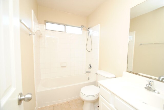 full bathroom with tile patterned flooring, tiled shower / bath, vanity, and toilet