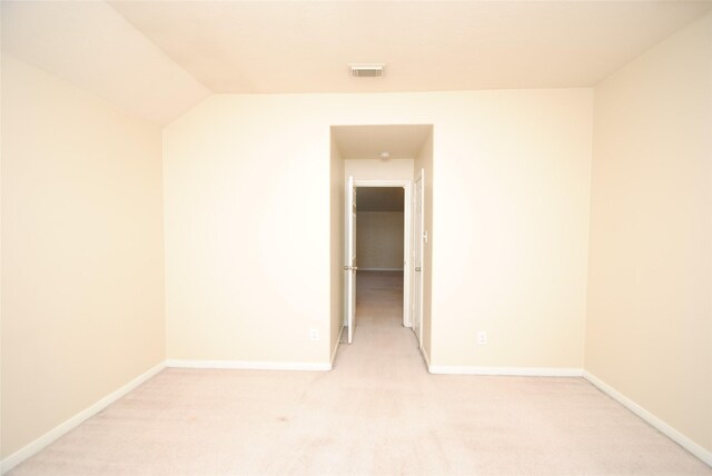 unfurnished room featuring light colored carpet