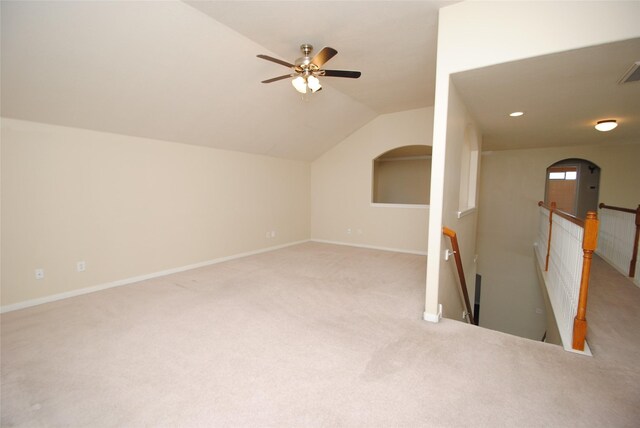 bonus room featuring vaulted ceiling, light carpet, and ceiling fan