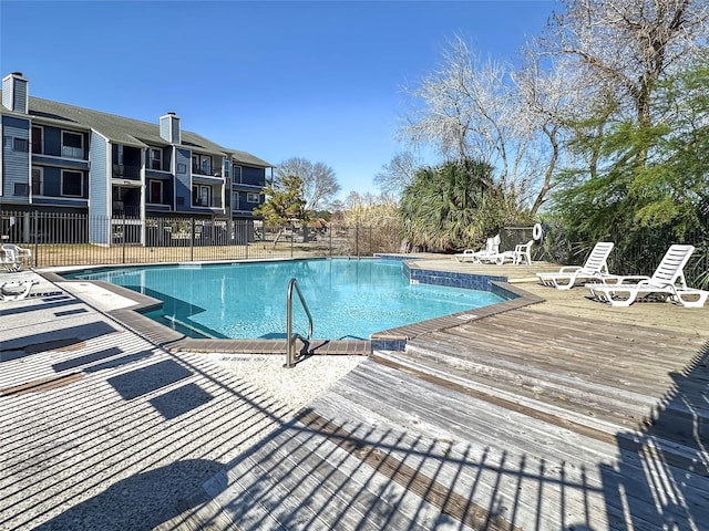 view of swimming pool with a deck