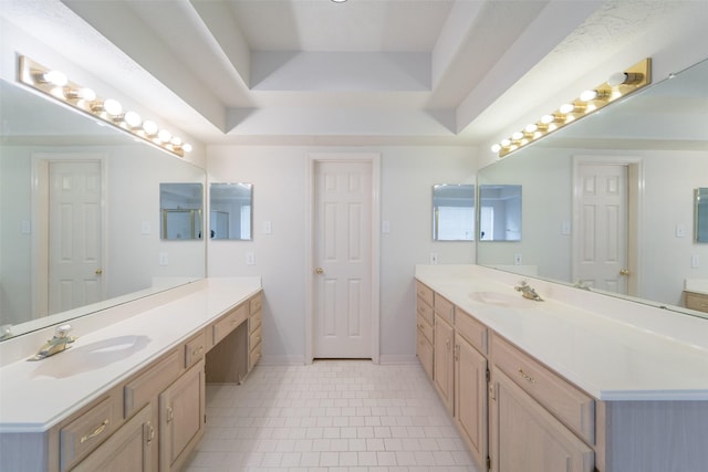 bathroom featuring vanity, tile patterned flooring, and a tray ceiling