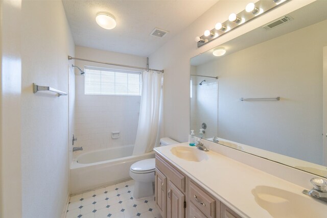 full bathroom featuring vanity, shower / tub combo, and toilet