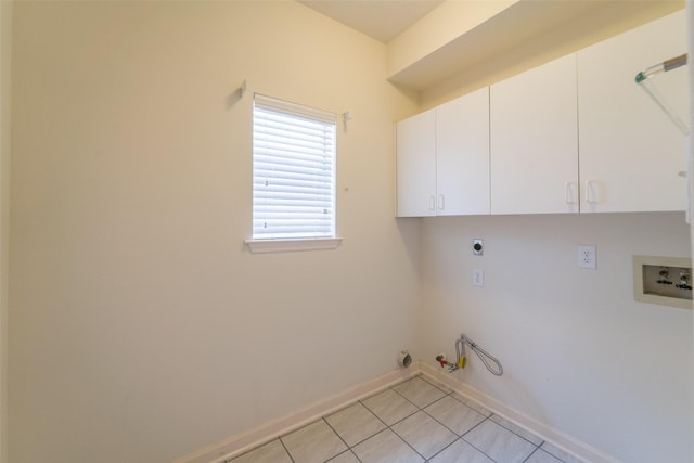 washroom with electric dryer hookup, cabinets, washer hookup, light tile patterned flooring, and hookup for a gas dryer