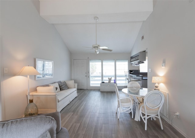 living room featuring dark wood-type flooring, ceiling fan, and high vaulted ceiling