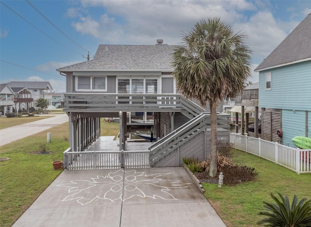 beach home featuring a front yard