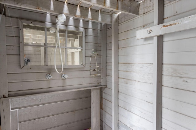 bathroom featuring wood walls