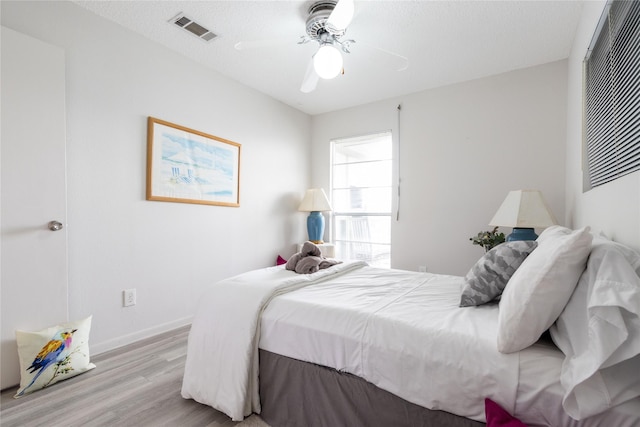 bedroom featuring light hardwood / wood-style flooring and ceiling fan