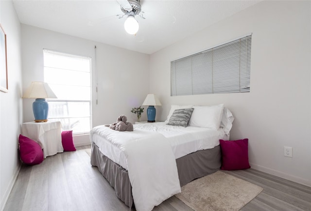 bedroom with ceiling fan and light hardwood / wood-style floors