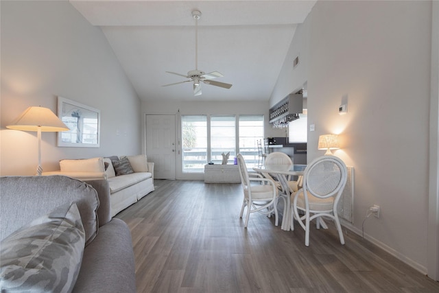 interior space with ceiling fan, dark hardwood / wood-style floors, and high vaulted ceiling