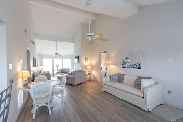 living room featuring hardwood / wood-style flooring, ceiling fan, beam ceiling, and high vaulted ceiling