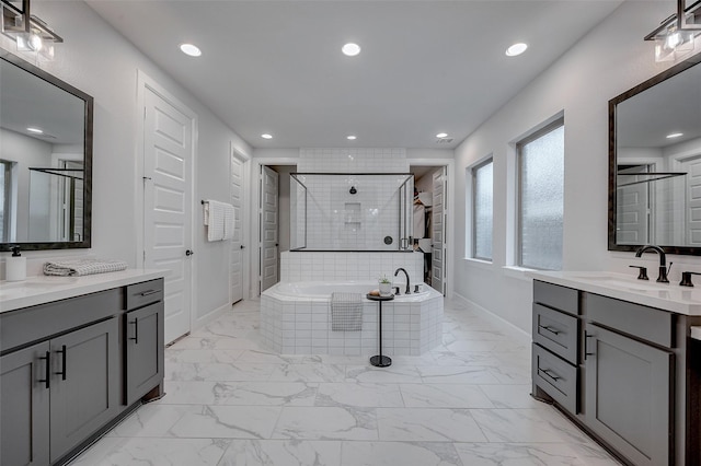 bathroom featuring a garden tub, recessed lighting, baseboards, marble finish floor, and a shower stall