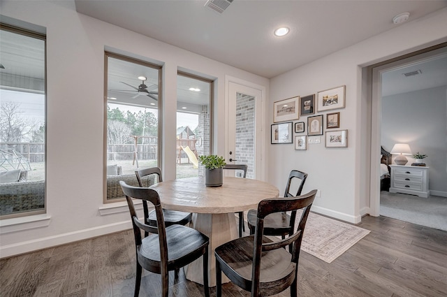 dining room with baseboards, visible vents, wood finished floors, and recessed lighting