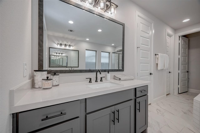 bathroom featuring visible vents, baseboards, marble finish floor, vanity, and recessed lighting