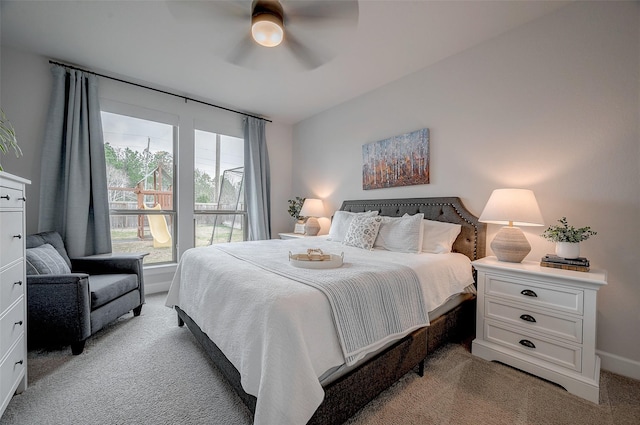 bedroom with a ceiling fan, light colored carpet, and baseboards