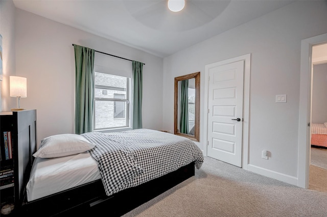 bedroom with light carpet, ceiling fan, and baseboards