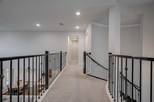 corridor with baseboards, recessed lighting, an upstairs landing, and light colored carpet