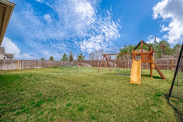 view of yard featuring a playground and a fenced backyard