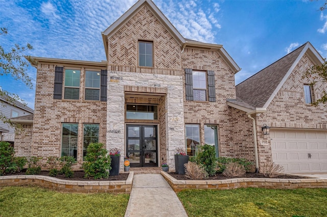 view of front facade featuring a garage, brick siding, stone siding, french doors, and a front lawn