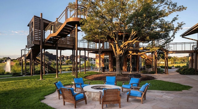 view of patio with an outdoor fire pit and stairway