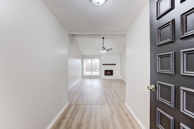 interior space with vaulted ceiling and light hardwood / wood-style flooring