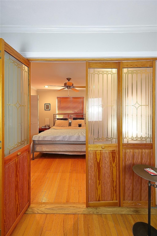 bedroom featuring ornamental molding and wood-type flooring