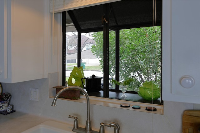 room details featuring white cabinetry and a sink