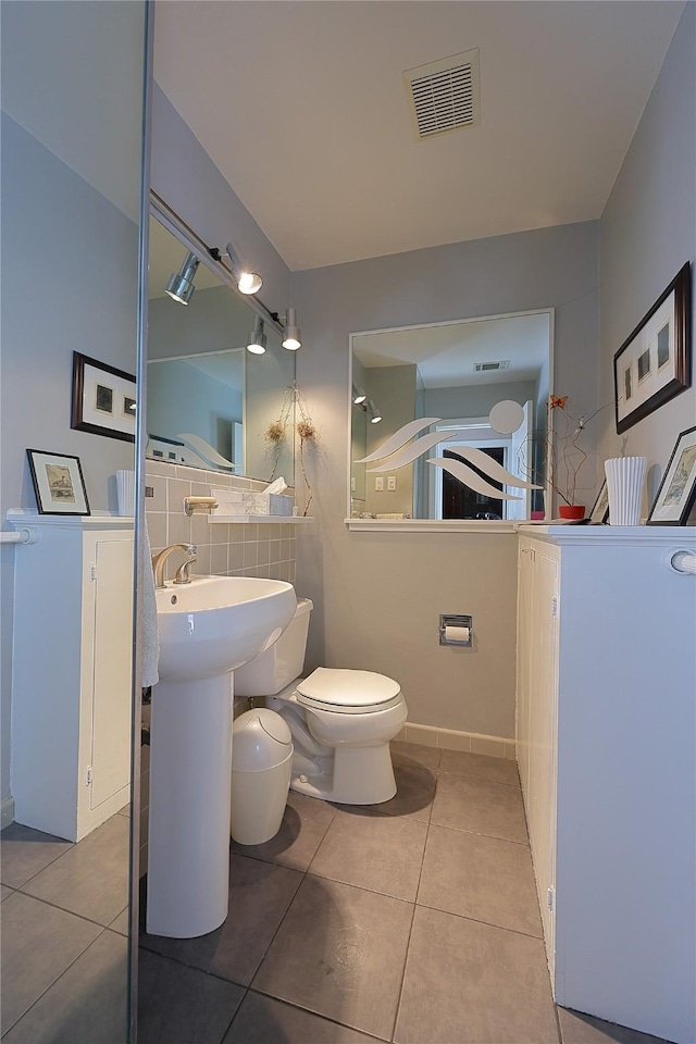 bathroom with toilet, tile patterned flooring, and visible vents