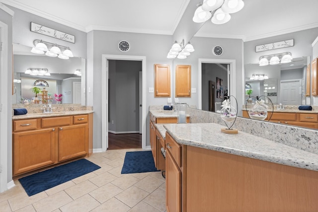 full bath with a chandelier, tile patterned floors, vanity, and ornamental molding