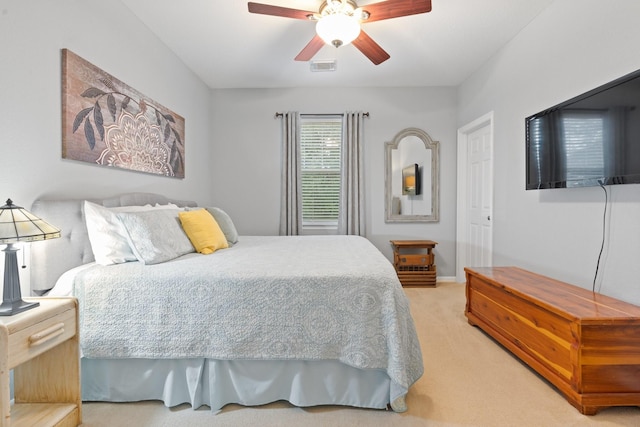 carpeted bedroom with baseboards, visible vents, and ceiling fan