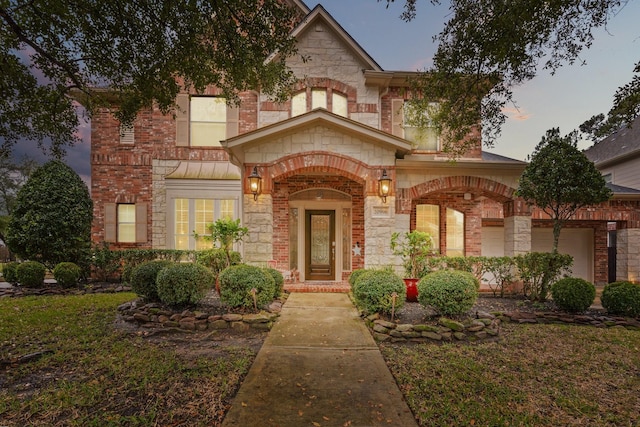 view of front facade featuring stone siding and brick siding