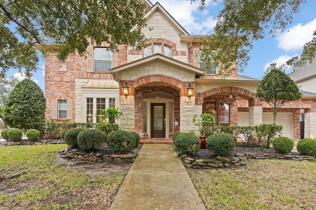 view of front of house featuring stone siding, brick siding, and a front yard