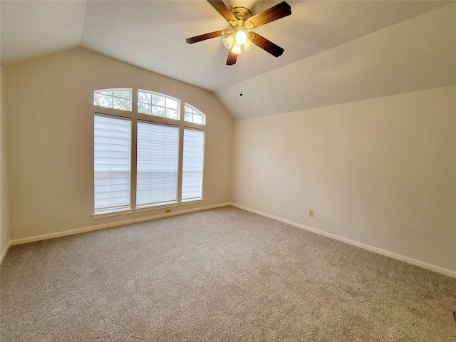 carpeted empty room with lofted ceiling and ceiling fan