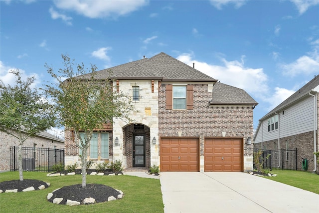 32962 Franklin Brooks Dr, Brookshire, TX 77423 - view of front of home featuring a shingled roof, a front lawn, fence, stone siding, and driveway