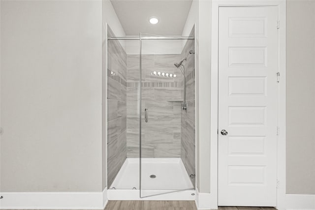 bathroom featuring a stall shower and baseboards