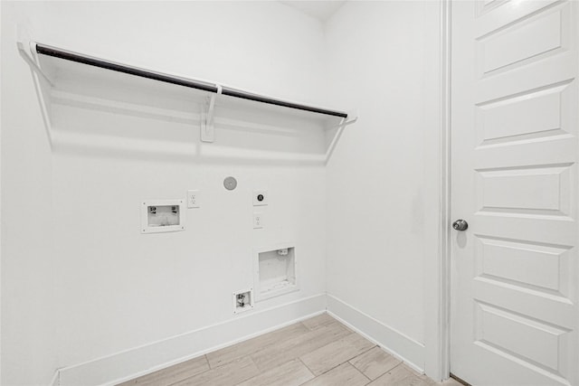 clothes washing area featuring hookup for a washing machine, gas dryer hookup, hookup for an electric dryer, laundry area, and light wood-style floors