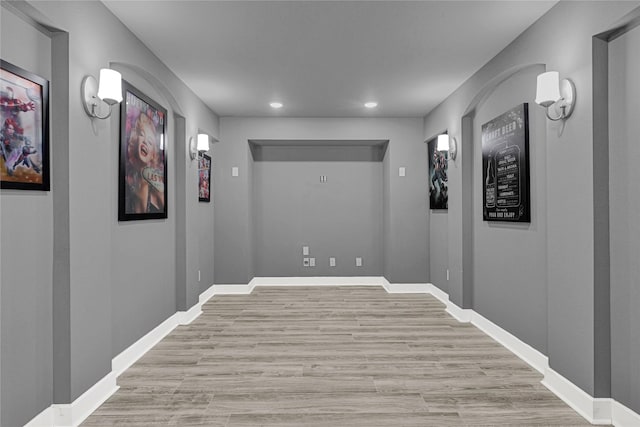 hall with light wood-style flooring, recessed lighting, and baseboards