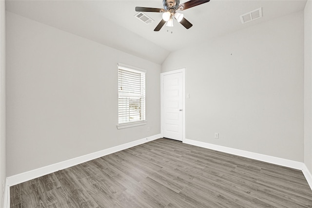 empty room featuring visible vents, baseboards, wood finished floors, and a ceiling fan