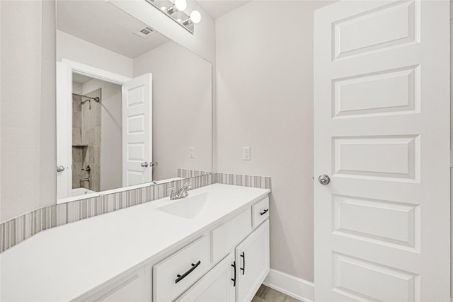 full bathroom featuring vanity and baseboards