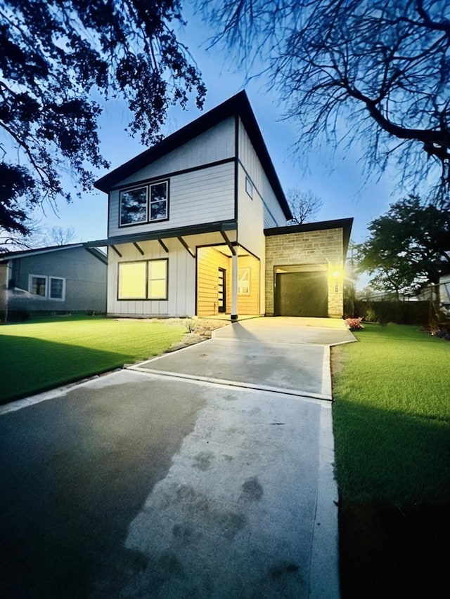 view of front of home with a front lawn and a garage