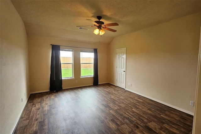 unfurnished room with dark wood-style floors, baseboards, visible vents, and a textured ceiling