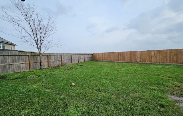 view of yard with a fenced backyard