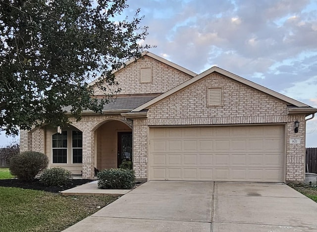 view of front of property featuring a garage and driveway