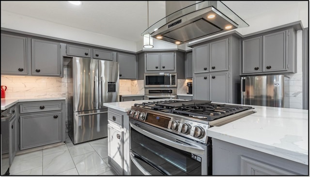 kitchen featuring gray cabinets, appliances with stainless steel finishes, extractor fan, light stone countertops, and decorative backsplash