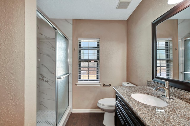 bathroom featuring vanity, hardwood / wood-style floors, and a shower with door