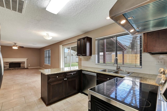 kitchen with sink, a brick fireplace, stainless steel dishwasher, kitchen peninsula, and range hood