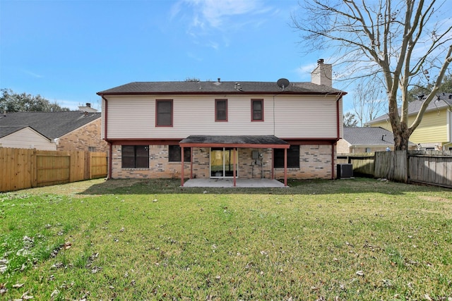 rear view of property featuring central AC unit, a yard, and a patio area