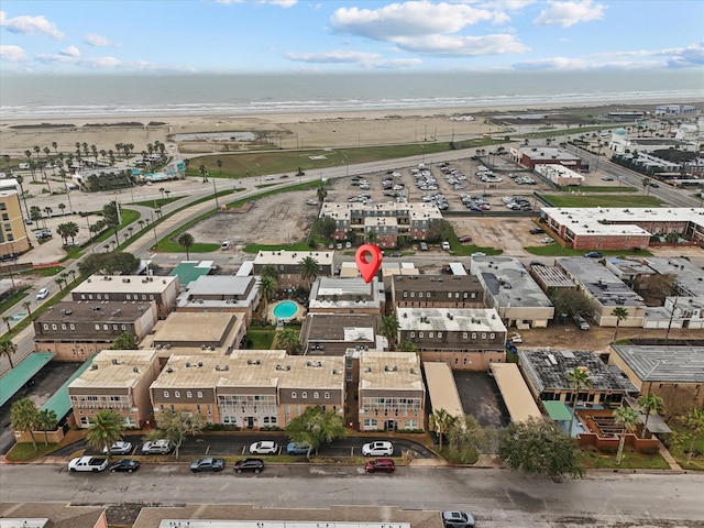 drone / aerial view featuring a beach view and a water view