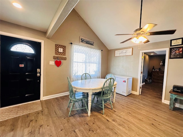 dining space with vaulted ceiling, light hardwood / wood-style floors, and ceiling fan