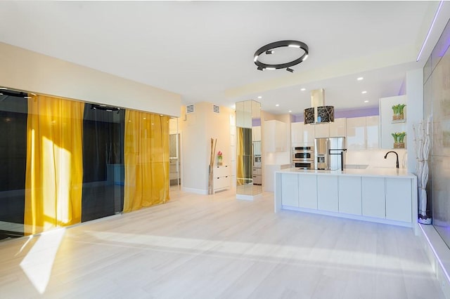 kitchen with sink, white cabinets, and appliances with stainless steel finishes